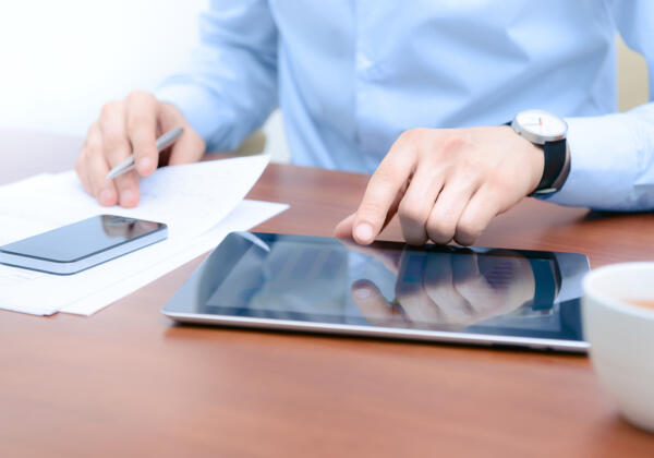 Small business accountant in Geelong office working on phone and ipad